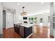 Bright kitchen with an island featuring stainless steel appliances and an adjacent living space at 4260 Hammond Bridge Dr, Suwanee, GA 30024