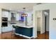 Well-lit kitchen with stainless steel appliances, modern lighting, a kitchen island, and white cabinets at 4260 Hammond Bridge Dr, Suwanee, GA 30024