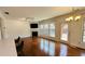 Open concept living room with hardwood floors, a fireplace, and large windows for natural light at 4260 Hammond Bridge Dr, Suwanee, GA 30024
