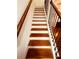 Staircase with white risers and wooden treads, complemented by an iron railing at 4260 Hammond Bridge Dr, Suwanee, GA 30024