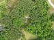 An aerial view showcasing the home surrounded by lush greenery and mature trees at 4615 Gresham Rd, Douglasville, GA 30134