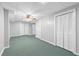 A spacious basement features neutral walls, green carpeting, and large closets with bi-fold doors at 4615 Gresham Rd, Douglasville, GA 30134