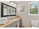 Bathroom featuring a large mirror, neutral walls, and natural light from a window at 4615 Gresham Rd, Douglasville, GA 30134