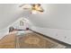 Attic bonus room featuring rugs on the floor, with white walls and a ceiling fan at 4615 Gresham Rd, Douglasville, GA 30134
