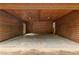 Enclosed carport features a concrete floor and stained wood walls and ceiling at 4615 Gresham Rd, Douglasville, GA 30134