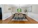 Dining room with an elegant table set near doors leading to the outside, featuring wainscotting at 4615 Gresham Rd, Douglasville, GA 30134