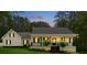 Charming single-story home featuring a well-manicured lawn, classic black and white trim, and a cozy front porch at 4615 Gresham Rd, Douglasville, GA 30134