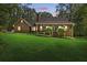 Inviting home featuring a well-manicured lawn and covered front porch nestled in mature trees at 4615 Gresham Rd, Douglasville, GA 30134