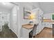 View of the kitchen with desk space, white cabinets, granite counters, and stainless oven at 4615 Gresham Rd, Douglasville, GA 30134