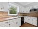 Kitchen with white cabinetry, countertops, stainless steel appliances, and large window at 4615 Gresham Rd, Douglasville, GA 30134