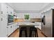 Bright kitchen featuring stainless steel appliances, white cabinets, and a center island at 4615 Gresham Rd, Douglasville, GA 30134