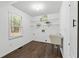 Bright laundry room featuring laminate flooring and a utility sink at 4615 Gresham Rd, Douglasville, GA 30134