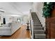 Spacious living room with staircase and hardwood floors seamlessly connects to the dining area at 4615 Gresham Rd, Douglasville, GA 30134
