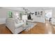 Spacious living room with hardwood floors, fireplace, and access to the kitchen area at 4615 Gresham Rd, Douglasville, GA 30134