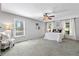Spacious main bedroom with plush carpeting, a ceiling fan, and lots of natural light at 4615 Gresham Rd, Douglasville, GA 30134