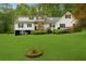 Spacious two-story home boasting a sprawling green lawn, black and white trim, and a private backyard at 4615 Gresham Rd, Douglasville, GA 30134