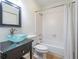 This bathroom has neutral floors, a modern vanity, a shower-tub, and a large mirror at 476 Sherman Way, Decatur, GA 30033