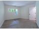 This bedroom has neutral carpet, a large window, and neutral paint at 476 Sherman Way, Decatur, GA 30033