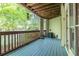 The outdoor deck has wooden floors, a wooden ceiling, an air conditioner, and overlooks a wooded area at 476 Sherman Way, Decatur, GA 30033