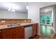 Kitchen view with stainless steel appliances, wood cabinets, granite counters, and a stylish backsplash at 476 Sherman Way, Decatur, GA 30033