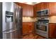 Modern kitchen featuring stainless steel appliances, wood cabinets, and granite countertops at 476 Sherman Way, Decatur, GA 30033