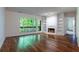 Bright living room features hardwood floors, a fireplace, built-in shelves, and a large window with natural light at 476 Sherman Way, Decatur, GA 30033