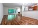 Open concept living room with hardwood floors, fireplace, and large window overlooking greenery at 476 Sherman Way, Decatur, GA 30033