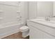 Clean bathroom featuring a shower and tub combination with a white vanity at 5599 Rosehall Pl, Atlanta, GA 30349