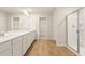 Bathroom showcasing a double vanity, shower, and walk-in closet access at 5599 Rosehall Pl, Atlanta, GA 30349