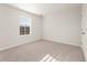 Carpeted bedroom featuring a window and door for easy access at 5599 Rosehall Pl, Atlanta, GA 30349