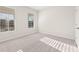 Light filled bedroom features large windows and plush carpet at 5599 Rosehall Pl, Atlanta, GA 30349