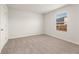 Neutral bedroom with carpet, window, and white door at 5599 Rosehall Pl, Atlanta, GA 30349