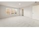 Spacious bedroom featuring plush carpeting and three bright windows at 5599 Rosehall Pl, Atlanta, GA 30349
