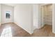 Bright entryway with wood floors leads to a bathroom with tub/shower combo at 5599 Rosehall Pl, Atlanta, GA 30349