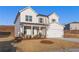 Charming two-story home featuring white siding, a covered porch, and an attached garage at 5599 Rosehall Pl, Atlanta, GA 30349
