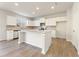 Island kitchen featuring white cabinets, stainless appliances, and wood floors at 5599 Rosehall Pl, Atlanta, GA 30349