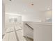 Bright upstairs landing featuring neutral carpeting, natural light, and staircase with wooden handrail at 5599 Rosehall Pl, Atlanta, GA 30349