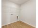 Bright laundry room with wood-look flooring and wire shelving for convenient storage solutions at 5599 Rosehall Pl, Atlanta, GA 30349