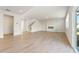 Spacious living room with light wood floors and a modern fireplace, perfect for entertaining at 5599 Rosehall Pl, Atlanta, GA 30349