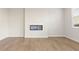 Modern living room featuring sleek wood floors and a contemporary electric fireplace at 5599 Rosehall Pl, Atlanta, GA 30349