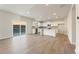 Open floorplan living room and kitchen with sliding glass door to the backyard at 5599 Rosehall Pl, Atlanta, GA 30349