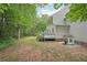 Backyard featuring deck with a playhouse set in a grassy yard at 120 Park Bridge Ln, Roswell, GA 30075