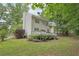 Exterior of the home featuring a deck, grassy yard and landscaping at 120 Park Bridge Ln, Roswell, GA 30075