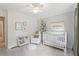 Charming Bedroom featuring a white crib, comfortable armchair, and stylish decor for a cozy, inviting space at 120 Park Bridge Ln, Roswell, GA 30075