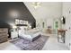 Inviting bedroom featuring a cozy bed, dedicated workspace, and dark accent wall for a stylish and functional space at 120 Park Bridge Ln, Roswell, GA 30075