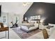 Spacious bedroom featuring a cozy bed, exercise bike, and dedicated workspace for a healthy and productive lifestyle at 120 Park Bridge Ln, Roswell, GA 30075