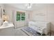 Cozy bedroom featuring a daybed with storage, stylish rug, and natural light from the window for a serene retreat at 120 Park Bridge Ln, Roswell, GA 30075