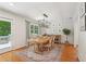 Charming dining room with hardwood floors, a wooden table, and a door that leads to the outdoor deck at 120 Park Bridge Ln, Roswell, GA 30075