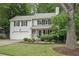 Traditional two-story home featuring a garage, green lawn, and mature tree at 120 Park Bridge Ln, Roswell, GA 30075