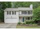 Charming two-story home with a well-manicured lawn and a welcoming front porch at 120 Park Bridge Ln, Roswell, GA 30075